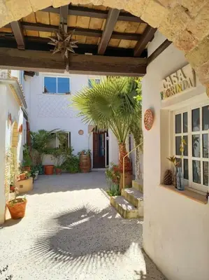 a courtyard of a building with a palm tree at Casa Florinda #5 in Jerez de la Frontera
