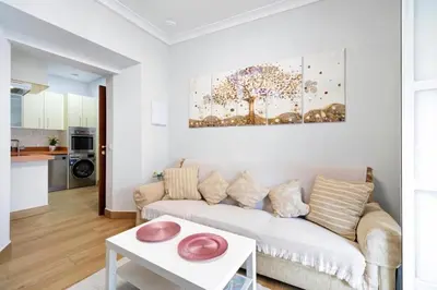 a living room with a couch and a table at Apartamento Casa Pili in El Puerto de Santa María