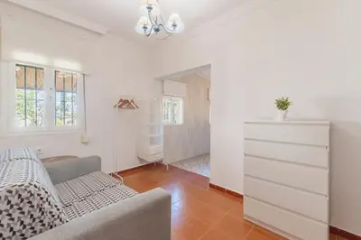 a living room with a couch and a dresser at Cadizz - Villa Verde- La Barrosa - ideal familias y grupos de amigos in Chiclana de la Frontera