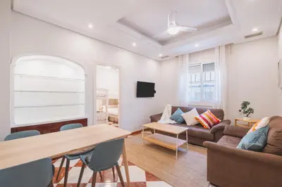 a living room with a couch and a table at El Pez Volador by Gades Gestión in Cádiz