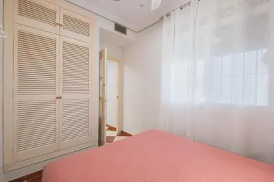 a bedroom with a bed and a window at El Pez Volador by Gades Gestión in Cádiz