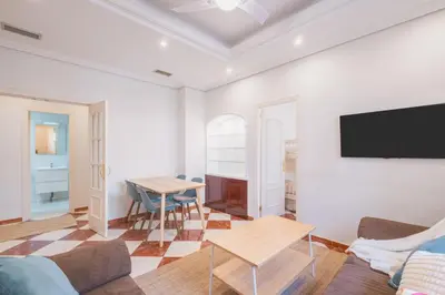 a living room with a couch and a table at El Pez Volador by Gades Gestión in Cádiz
