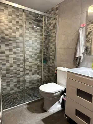 a bathroom with a shower and a toilet and a sink at Jerez Rincón de Chloe y Julieta in Jerez de la Frontera