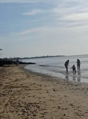 a group of people playing in the sand on the beach at Apartamento Crucero 2, la Jara in Sanlúcar de Barrameda