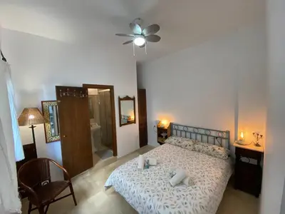 a bedroom with a bed and a ceiling fan at Apartamento Crucero 2, la Jara in Sanlúcar de Barrameda