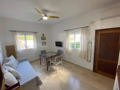 a living room with a couch and a table at Apartamento Crucero 2, la Jara in Sanlúcar de Barrameda
