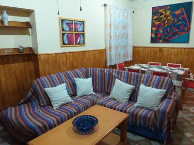 a living room with a couch and a table at Casa araceli in Chipiona