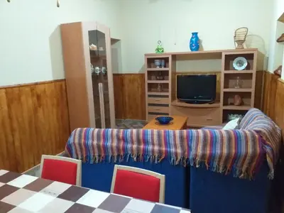 a living room with a couch and a tv at Casa araceli in Chipiona