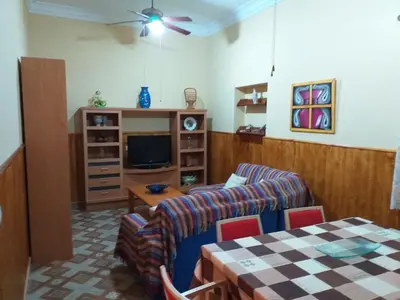 a living room with a couch and a tv at Casa araceli in Chipiona