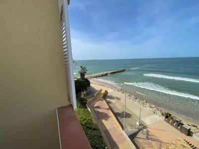 a view of the beach from the balcony of a building at Primera Línea Playa el Manantial in El Puerto de Santa María