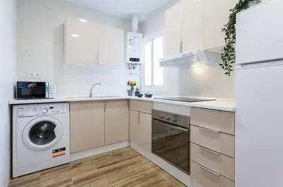 a white kitchen with a washing machine and a sink at Playa Santa Maria Moderno 3 Rooms in Cádiz