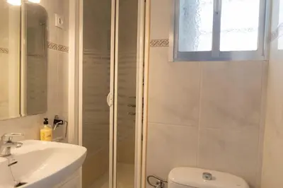 a bathroom with a shower and a toilet and a sink at Hogar del Sur by Gades Gestión in Cádiz
