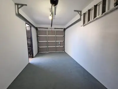 an empty garage with a door and a window at Casa Las Golondrinas in Rota