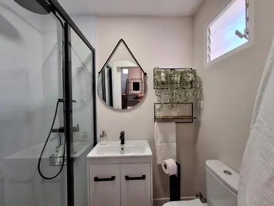 a bathroom with a sink and a mirror at Casa Las Golondrinas in Rota