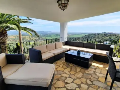 a living room with a couch and a table at »Casa Conil Buena Vista« in Conil de la Frontera