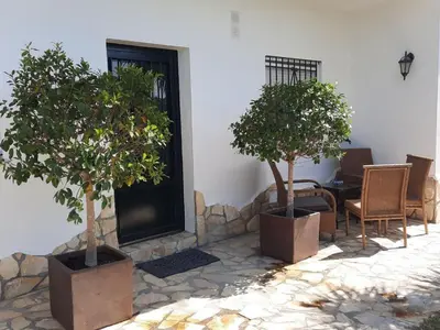 three potted trees sitting in front of a building at »Casa Conil Buena Vista« in Conil de la Frontera