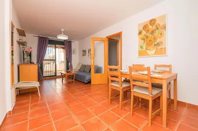 a living room with a table and chairs at Oasis Playero in Chiclana de la Frontera