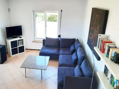 a living room with a blue couch and a table at Torre Andaluz Villa con piscina 2 habitaciones in Cádiz