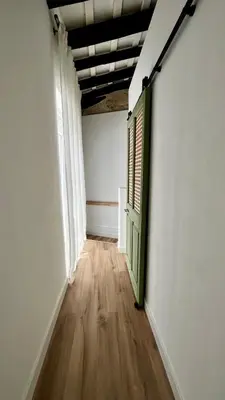 an empty room with a door and a wooden floor at El Taller in Jerez de la Frontera