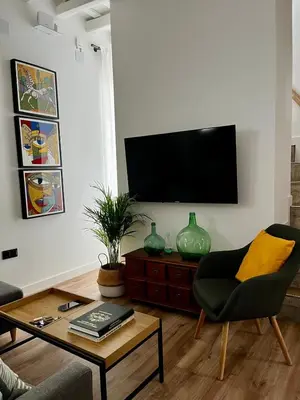 a living room with a flat screen tv on a wall at El Taller in Jerez de la Frontera