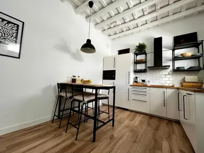 a kitchen with a table and chairs in a room at El Taller in Jerez de la Frontera