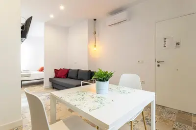 a white table and chairs in a living room at Casa Palacio La Lola y Olé Gran Terraza in Jerez de la Frontera