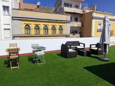 a patio with chairs and tables on the grass at Casa Palacio La Lola y Olé Gran Terraza in Jerez de la Frontera