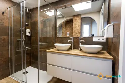 a bathroom with two sinks and a shower at Buenos Aires by LiveWork in Cádiz