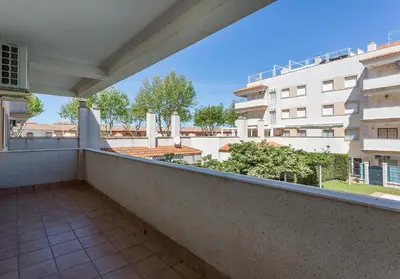 a balcony with a view of a building at Laguna 3 Rooms Piscina in Chipiona
