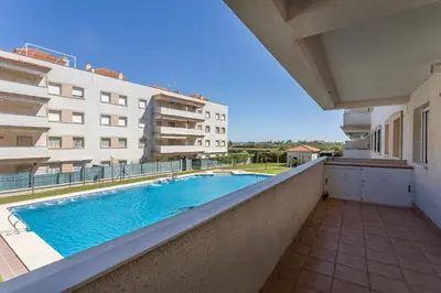 a view from the balcony of a building with a swimming pool at Laguna 3 Rooms Piscina in Chipiona