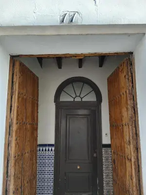 a black door in a room with a white wall at Casa Florinda #4 in Jerez de la Frontera