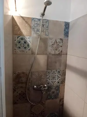 a shower in a bathroom with tiles on the wall at Casa Florinda #4 in Jerez de la Frontera