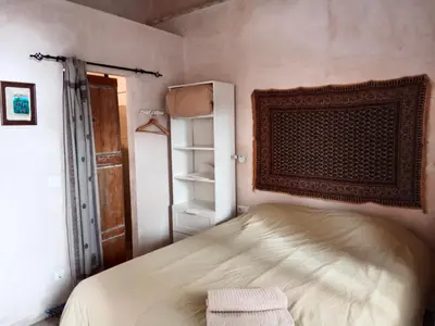a small bedroom with a bed and an open closet at Casa Florinda #4 in Jerez de la Frontera