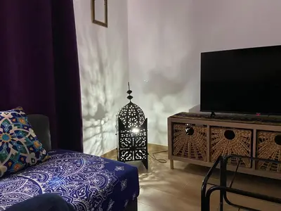 a living room with a tv and a table with a lamp at La Pequeña Morada in Arcos de la Frontera