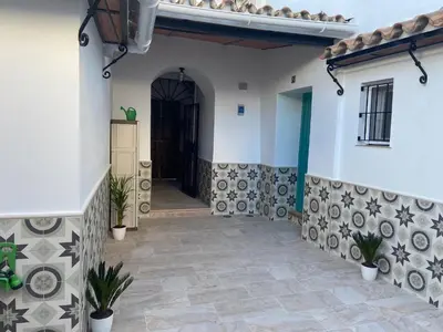 a hallway of a house with a black door at La Pequeña Morada in Arcos de la Frontera
