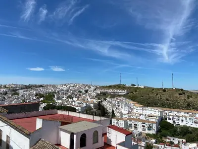 a view of a city with buildings on a hill at La Pequeña Morada in Arcos de la Frontera