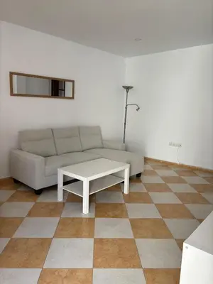 a living room with a couch and a table at Asís 20.7 in Medina Sidonia
