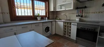 a kitchen with a sink and a washing machine at Apartamento atico Terraza Centro in El Puerto de Santa María