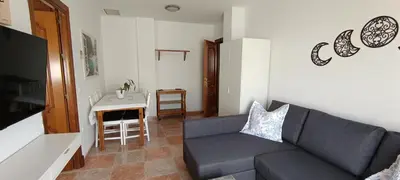a living room with a couch and a table at Apartamento atico Terraza Centro in El Puerto de Santa María