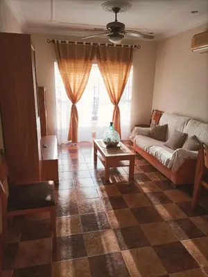 a living room with a couch and a table at Villa con piscina in Chiclana de la Frontera
