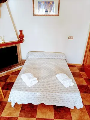 a bed in a room with two towels on it at Villa con piscina in Chiclana de la Frontera