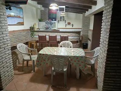 a dining room with a table and chairs at Villa con piscina in Chiclana de la Frontera