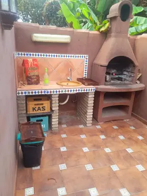 a pretend kitchen with a sink and a oven at Villa con piscina in Chiclana de la Frontera