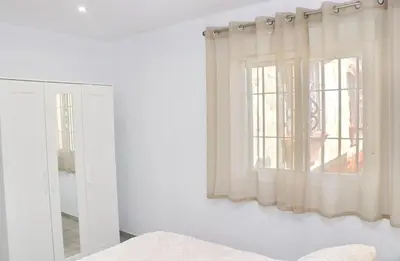 a bedroom with a window and a mirror at Apartamento Rural Marisma in Hozanejos