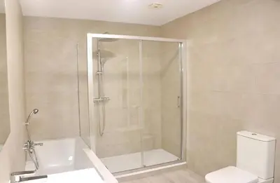 a bathroom with a shower with a toilet and a sink at Apartamento Rural Marisma in Hozanejos