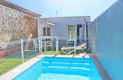 a swimming pool in the backyard of a house at Apartamento Rural Marisma in Hozanejos
