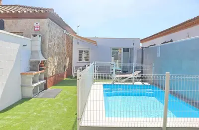 a swimming pool in the backyard of a house at Apartamento Rural Marisma in Hozanejos