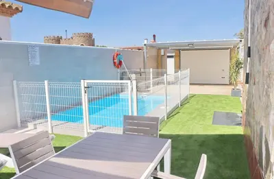 a patio with a table and a swimming pool at Apartamento Rural Marisma in Hozanejos