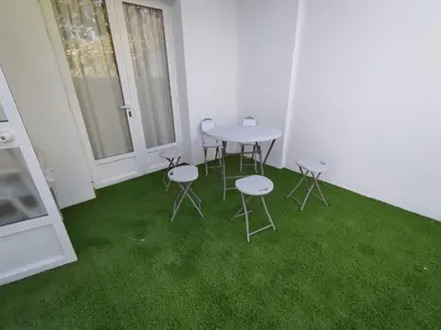 a room with a table and chairs and green grass at Brisas del Guadalquivir in Sanlúcar de Barrameda