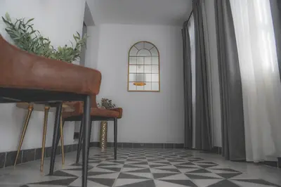 a room with two stools on a checkered floor at Casa Herrete 15 in Medina Sidonia